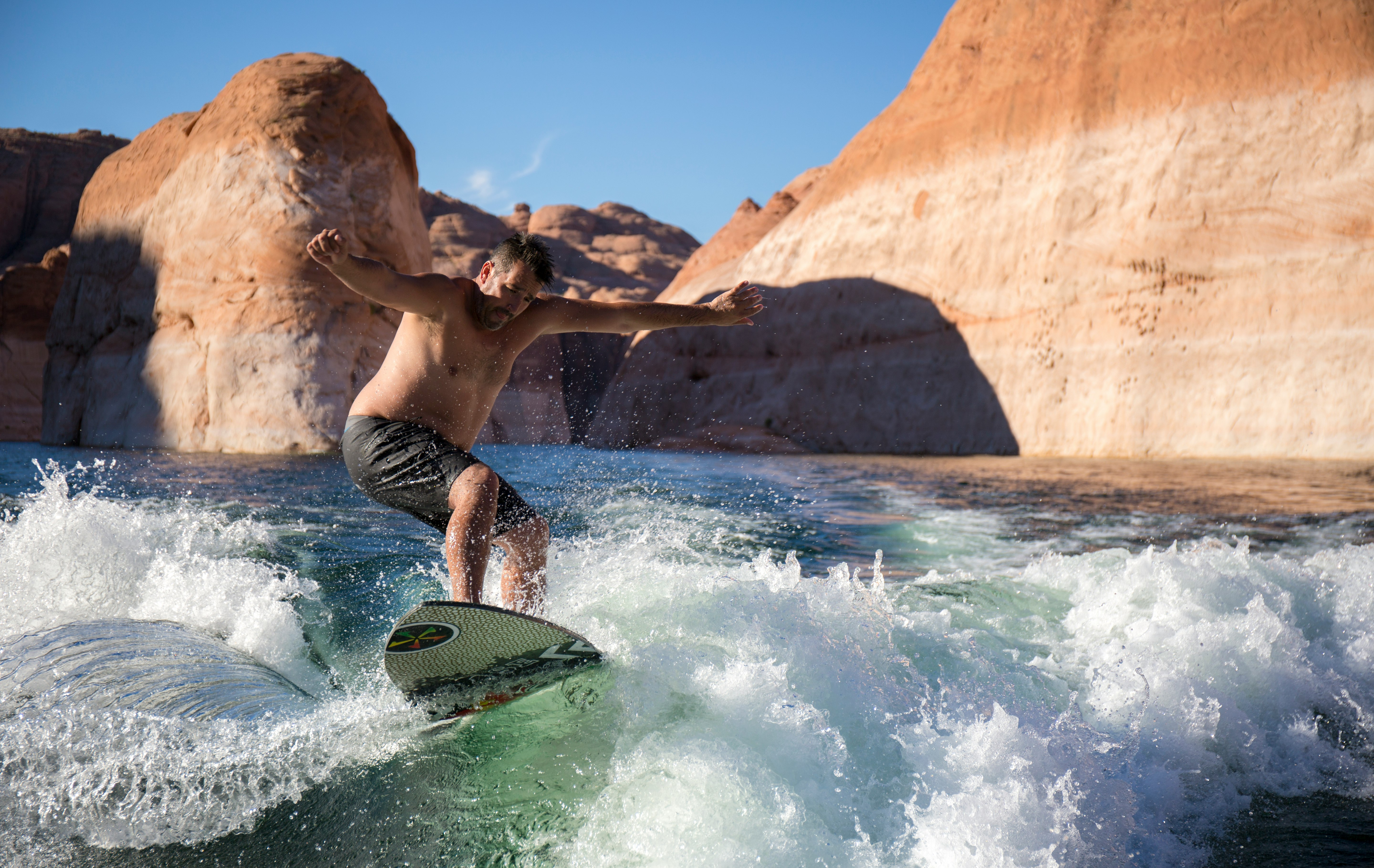 man riding surfboard during daytime